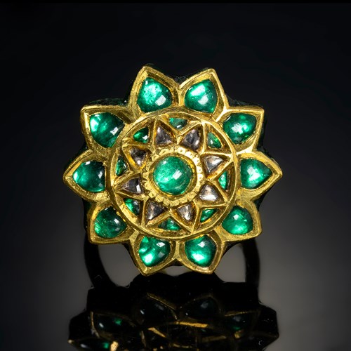 A 20th century Indian gold and enamel ring with foiled emeralds.